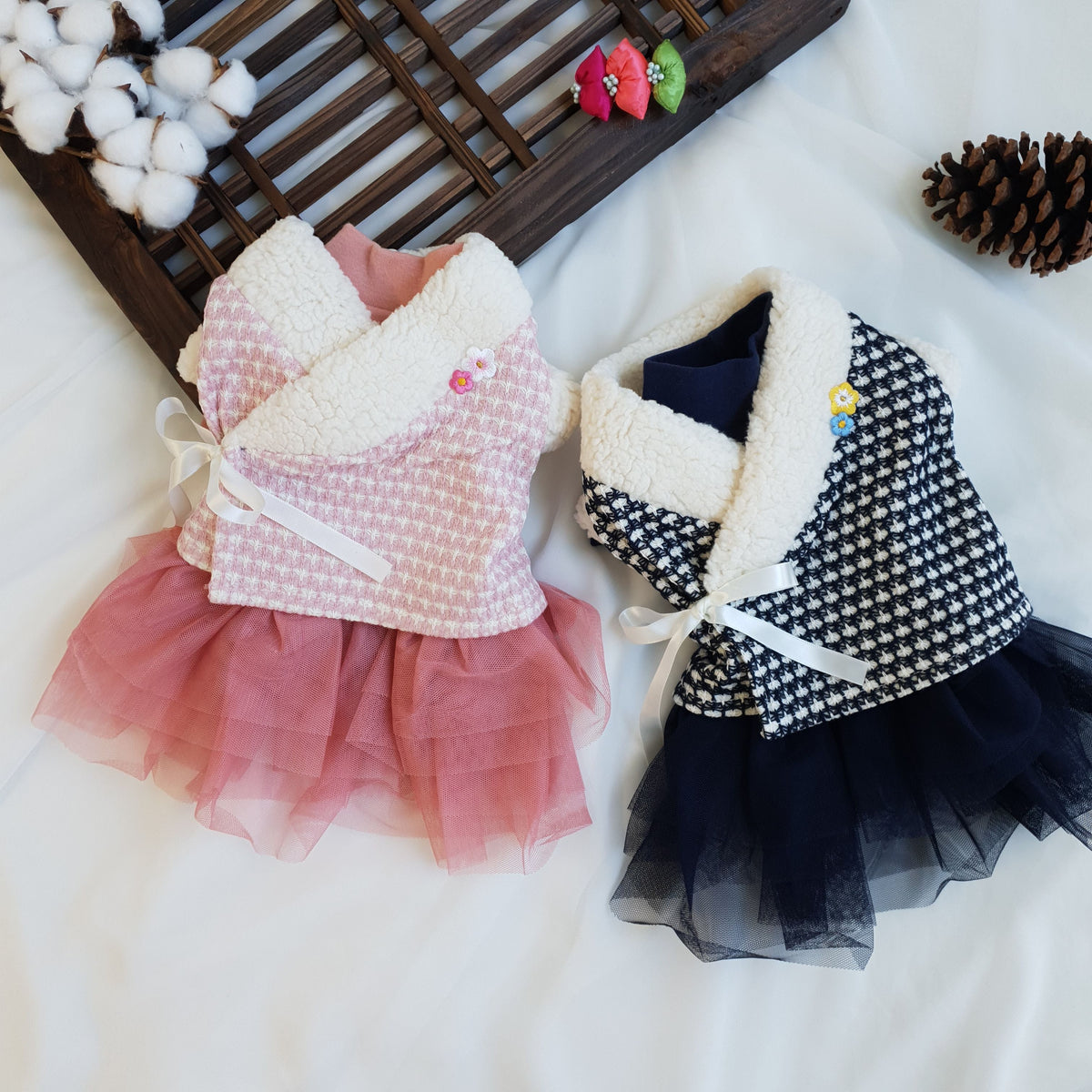 Two NKpup pet hanboks featuring houndstooth patterns and tulle skirts in pink and navy blue.