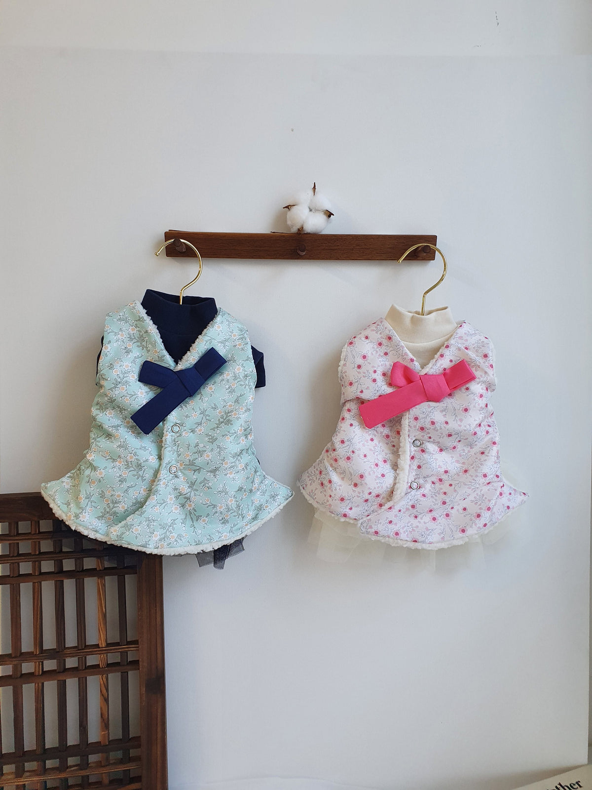 Floral fleece pet hanbok vests with bow details in light blue and pink.