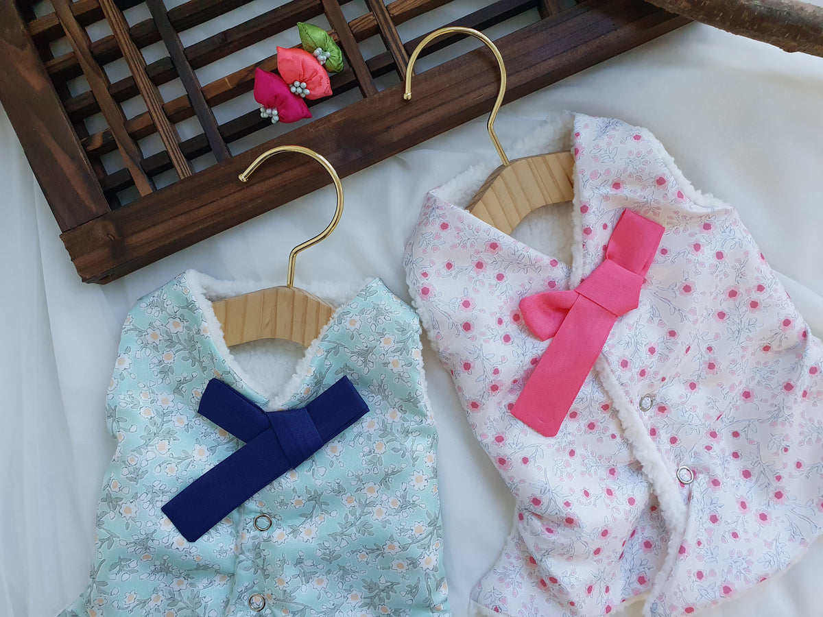 Floral fleece pet hanbok vests in mint and pink with decorative bows by NKpup.