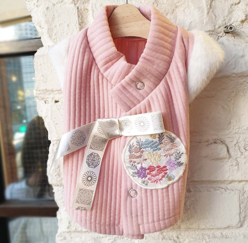 Pink cotton ribbed pet hanbok vest with floral embroidery and decorative ribbon.