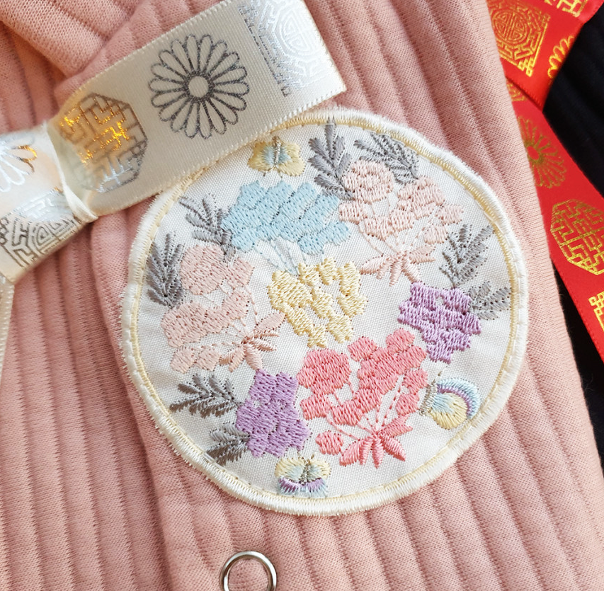 Embroidered floral patch on a pink cotton ribbed pet hanbok vest by NKpup