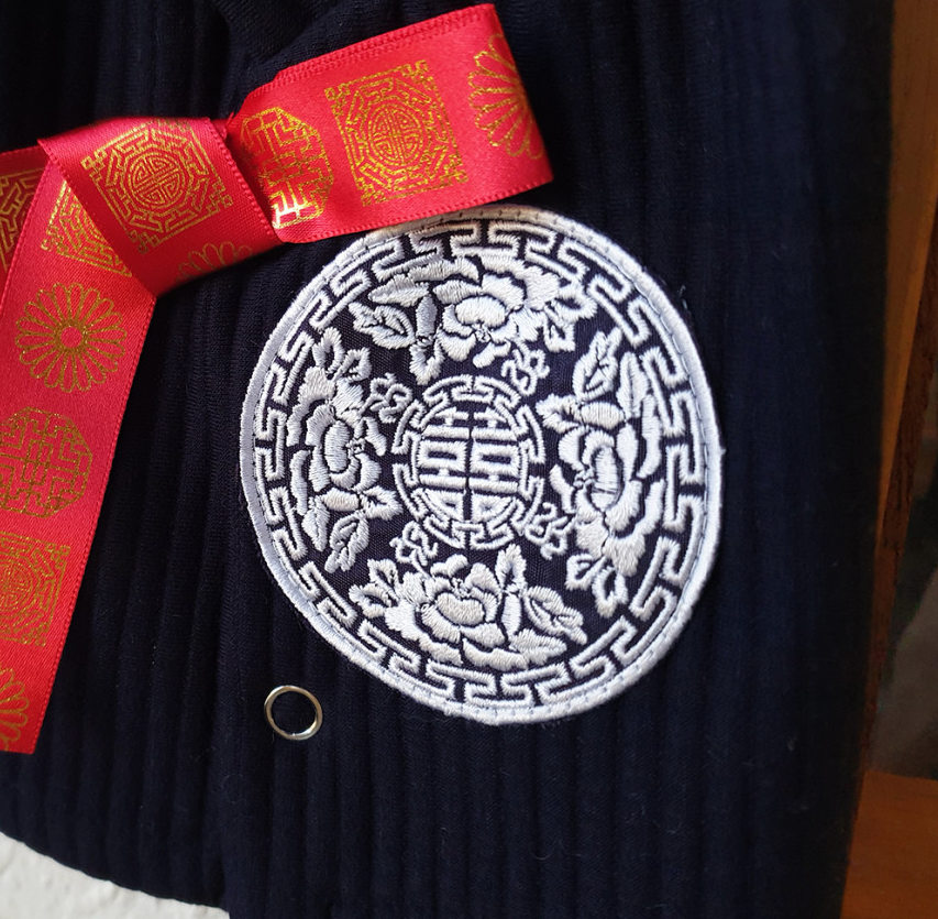 Navy blue cotton ribbed pet hanbok vest with white floral embroidery and red ribbon detail