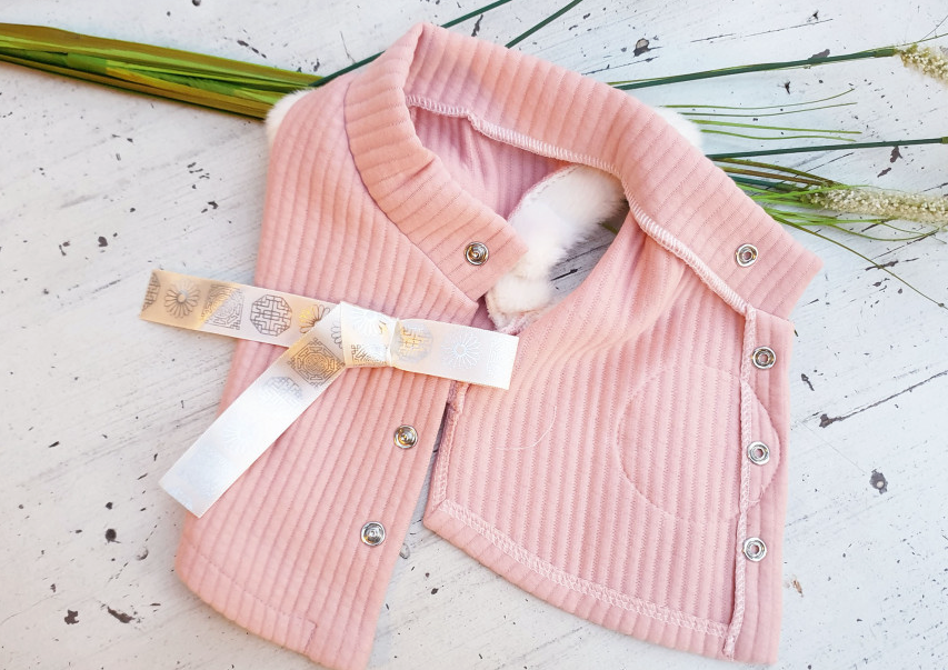Pink cotton ribbed pet hanbok vest with white faux fur trim and decorative gold ribbon
