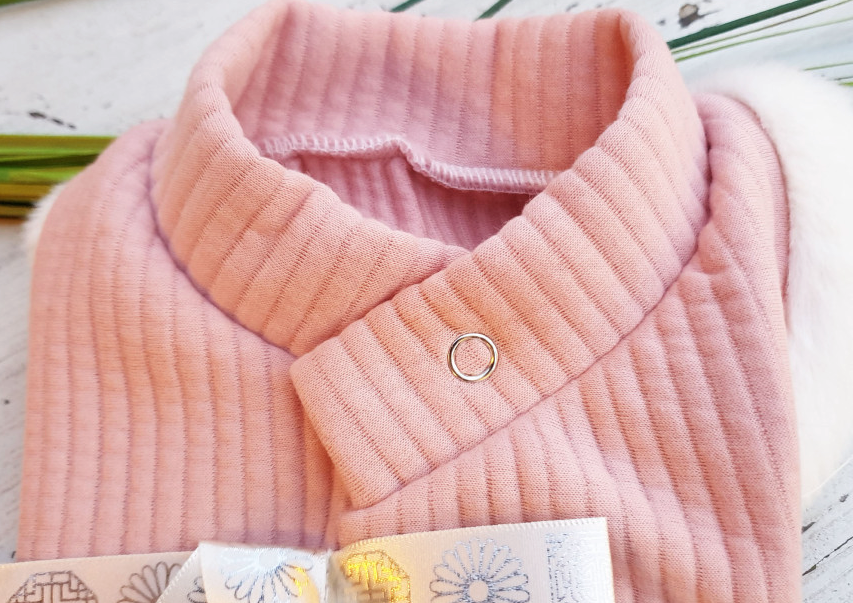 Pink cotton ribbed pet hanbok vest with a silver snap closure.