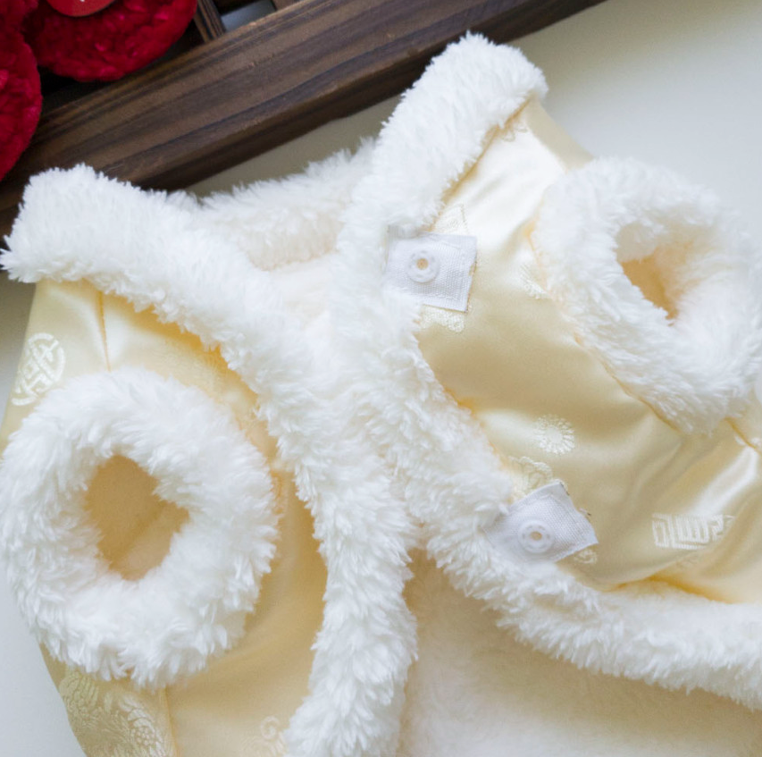 Cream-colored NKpup faux fur vest pet hanbok with plush white trim and traditional patterns
