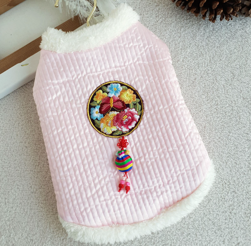 Pastel pink quilted pet hanbok vest with floral embroidery and traditional norigae tassel