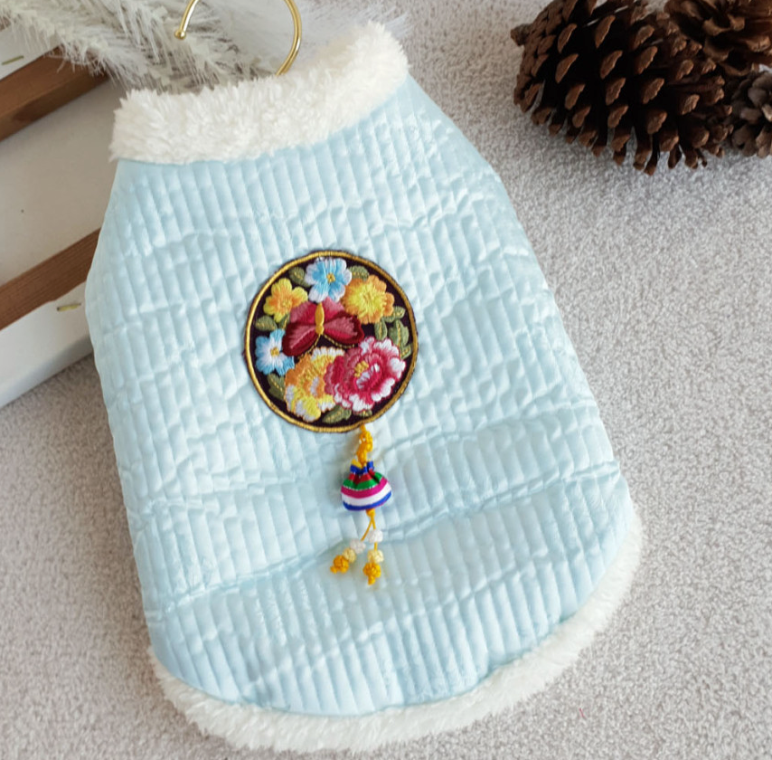 Pastel blue quilted pet hanbok vest with floral embroidery and traditional norigae tassel