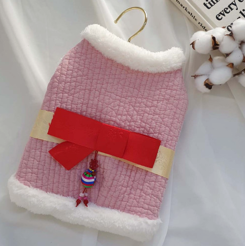 Pink quilted cotton pet hanbok vest with white faux fur trim and red decorative norigae tassel.