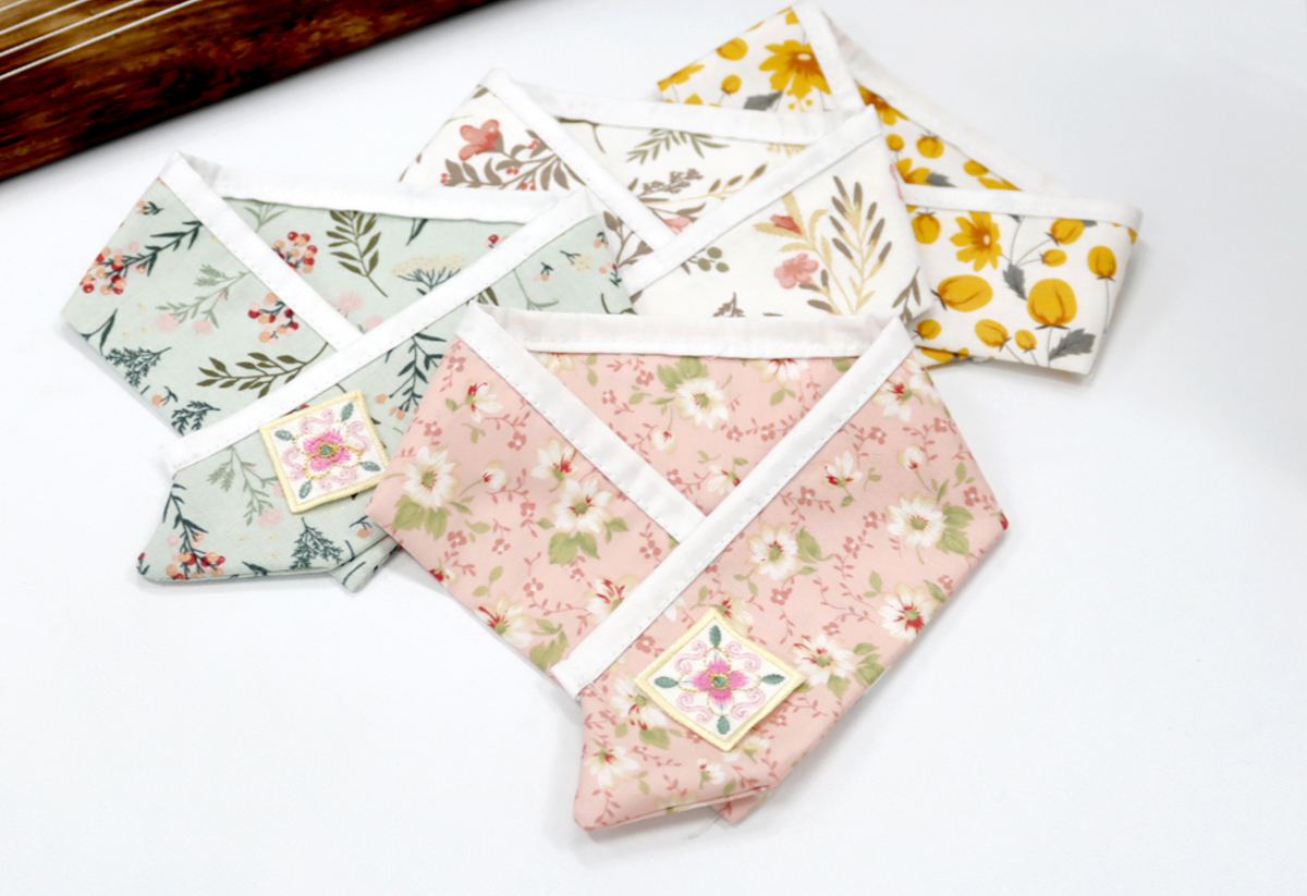 Floral Saekdong pet hanbok capes in pink, mint, white, and yellow floral patterns by NKpup