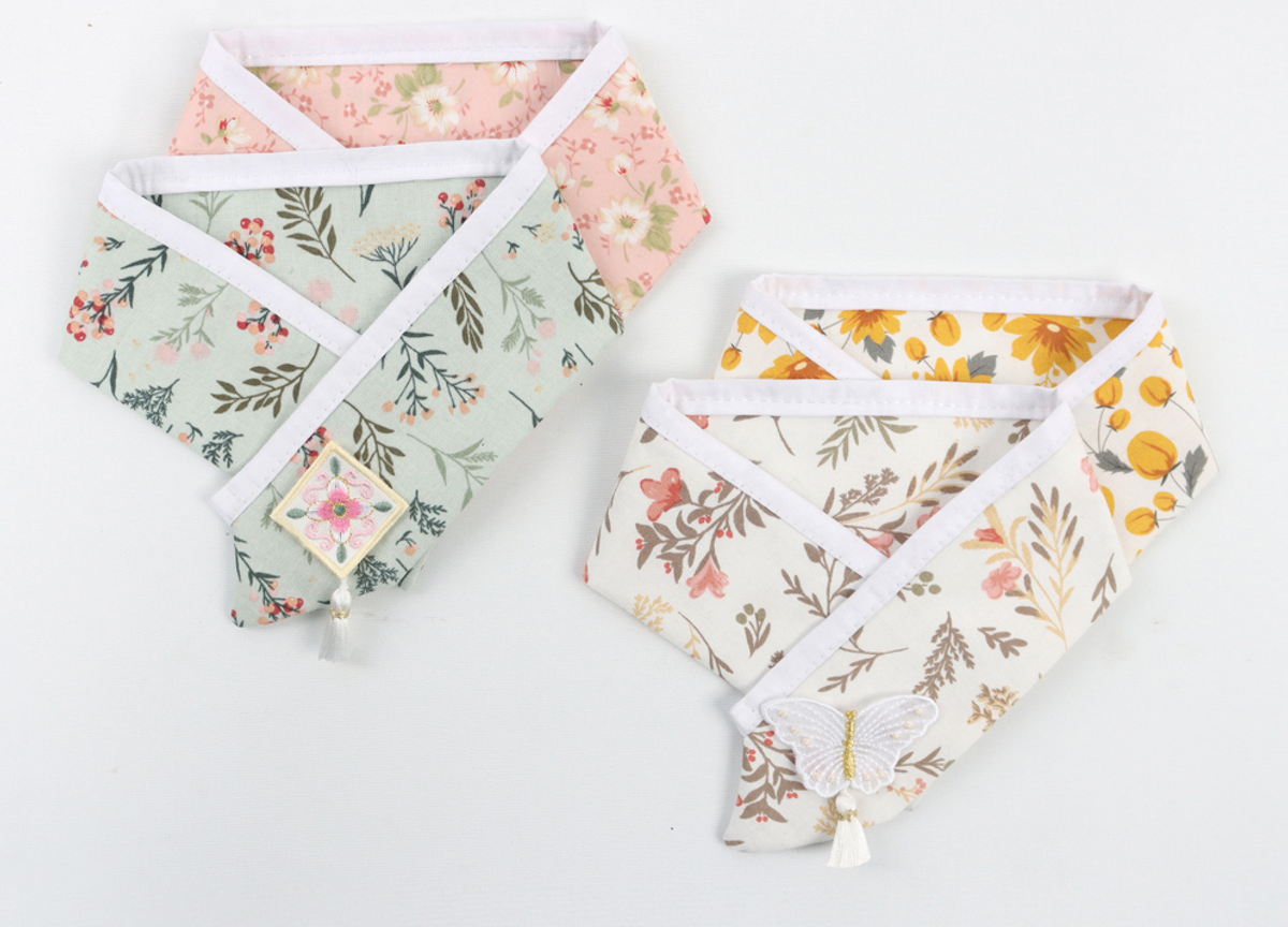 Floral Saekdong pet hanbok capes in pink, mint, and yellow patterns by NKpup