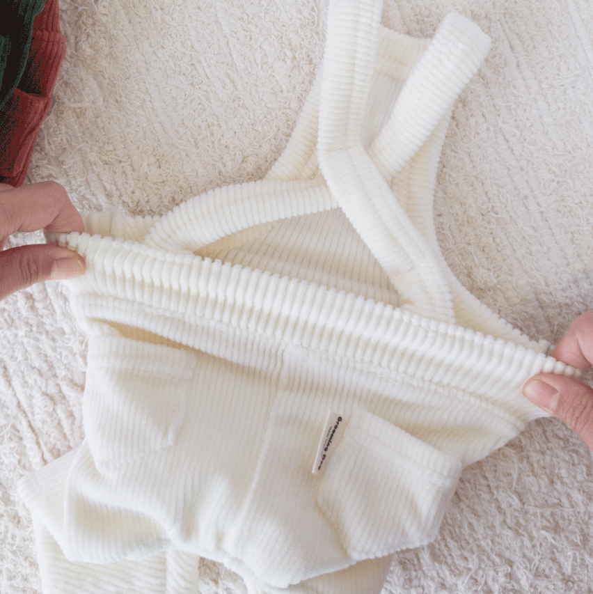 Cream corduroy dog suspender overalls with textured fabric