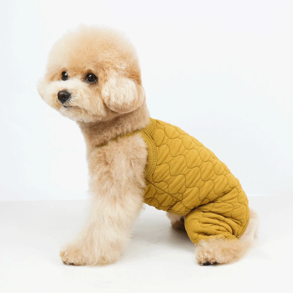 NKpup natural quilted dog overall in a mustard yellow color with a scalloped quilted pattern