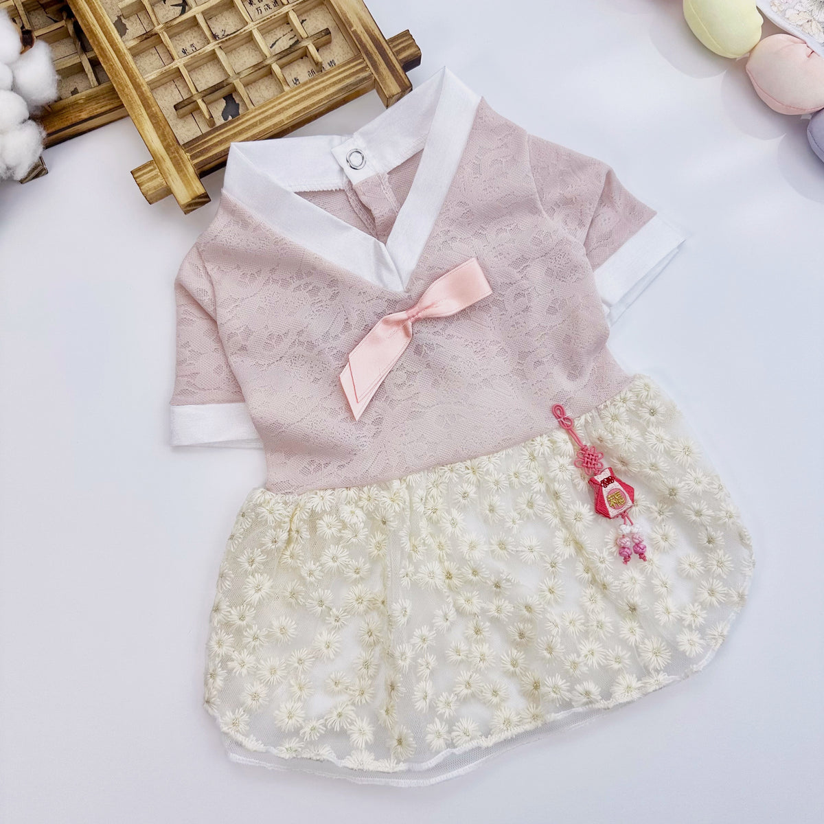 Pink and cream lace floral pet hanbok dress with a pink bow and decorative norigae