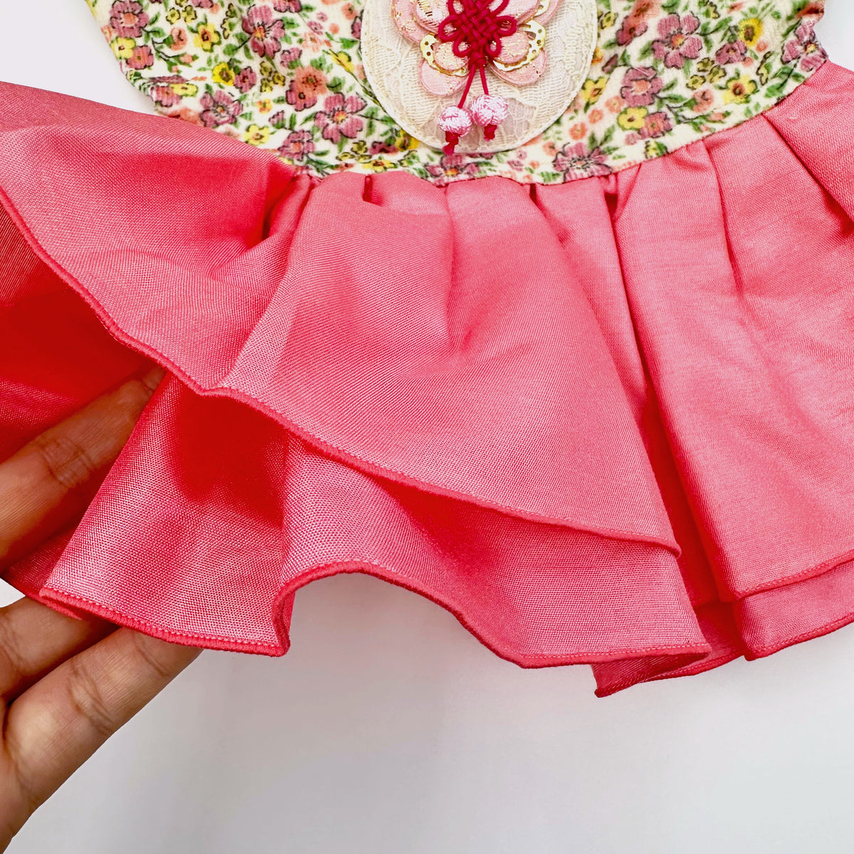 Close-up of a Retro Floral Pet Hanbok by NKpup featuring a pink ruffled skirt and floral bodice.