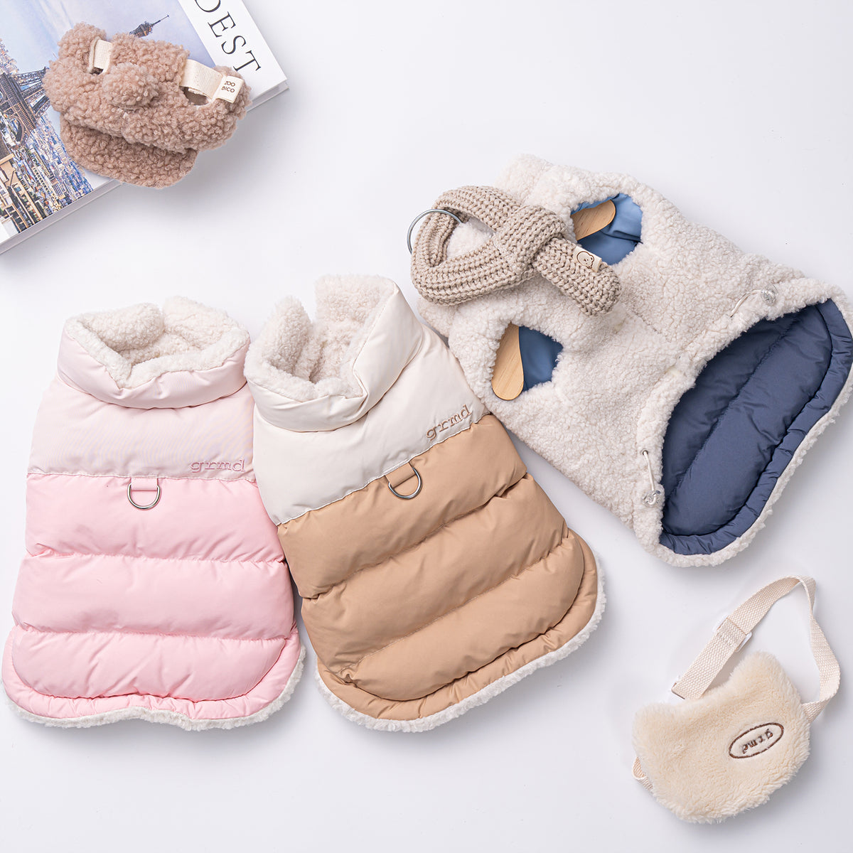 Reversible Snow Bear D-Ring padded dog vests in pink, beige, and white sherpa fleece.