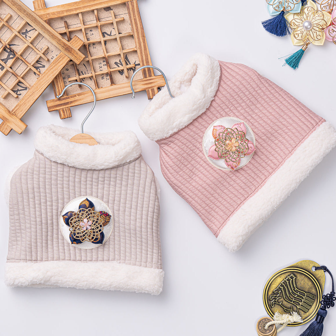 Two textured hats with decorative pins on a light background