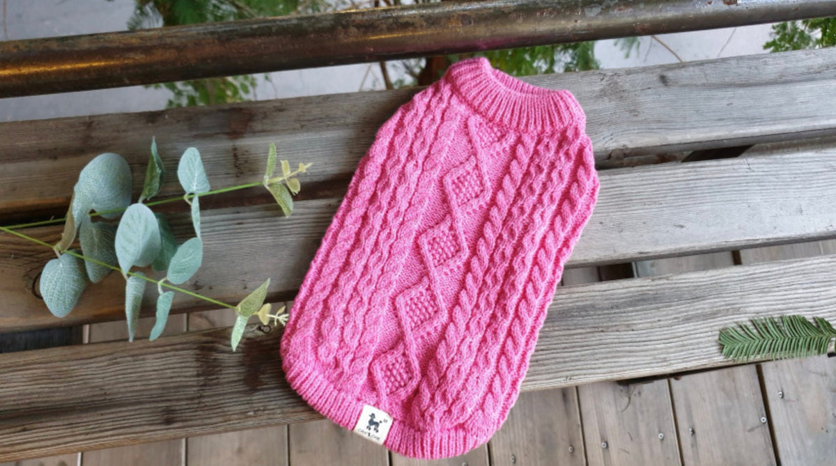 Pink round cable knit dog vest with diamond pattern