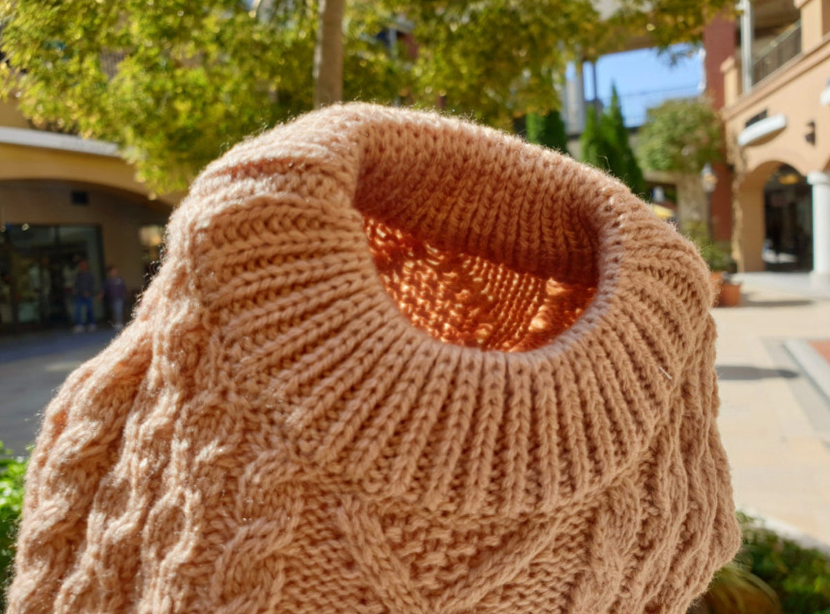 Tan round cable knit dog vest with a ribbed neckline