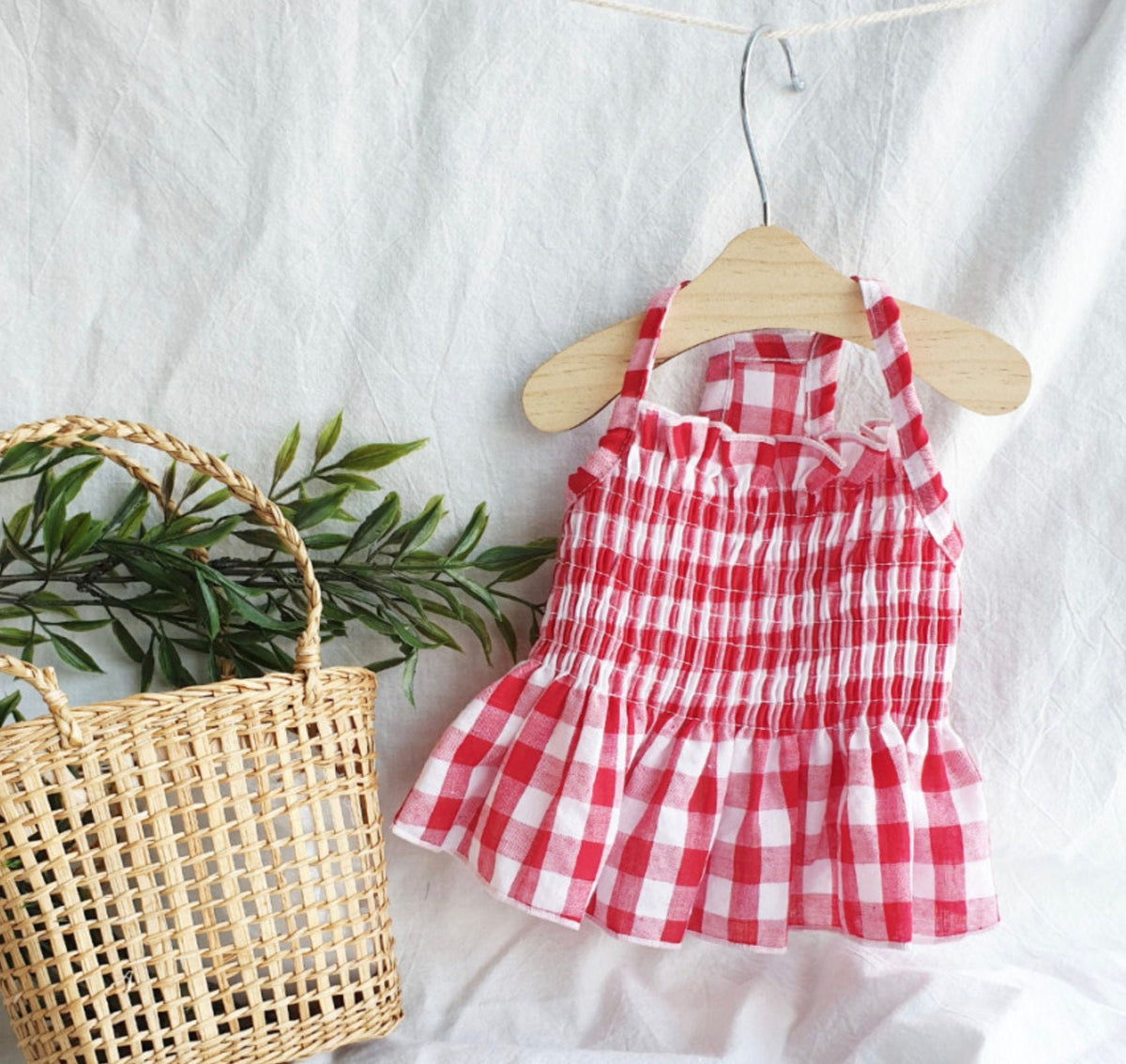 Red and white gingham smocked dog dress with ruffled skirt
