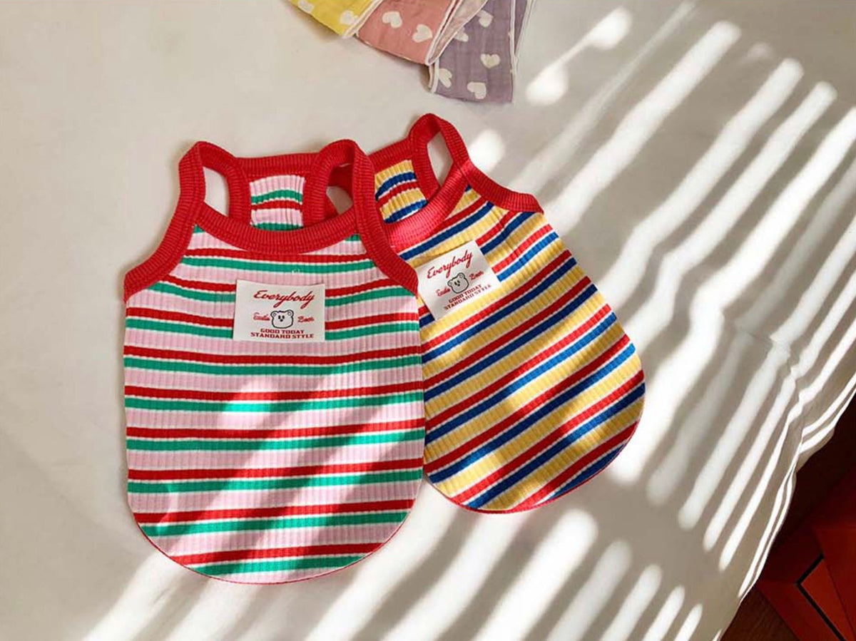 Two striped ribbed pet dog tops in red, white, and blue and red, white, and green colors.