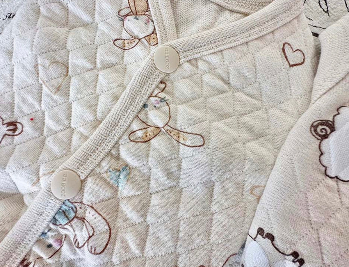 Cream quilted cotton dog vest with cute animal prints and button closures