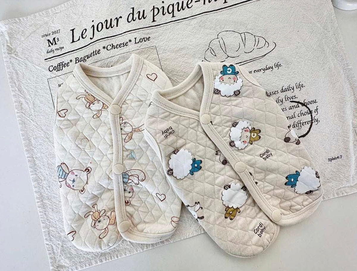 Cream quilted cotton dog vest with cute animal patterns and decorative sheep patches.