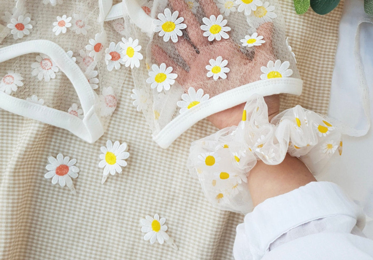 White mesh pet clothing and matching scrunchie featuring embroidered yellow and white daisies.