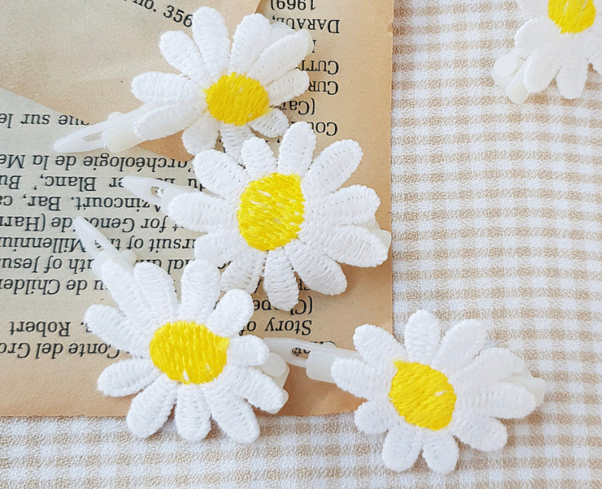 Embroidered daisy dog hairpins with white petals and yellow centers by NKpup