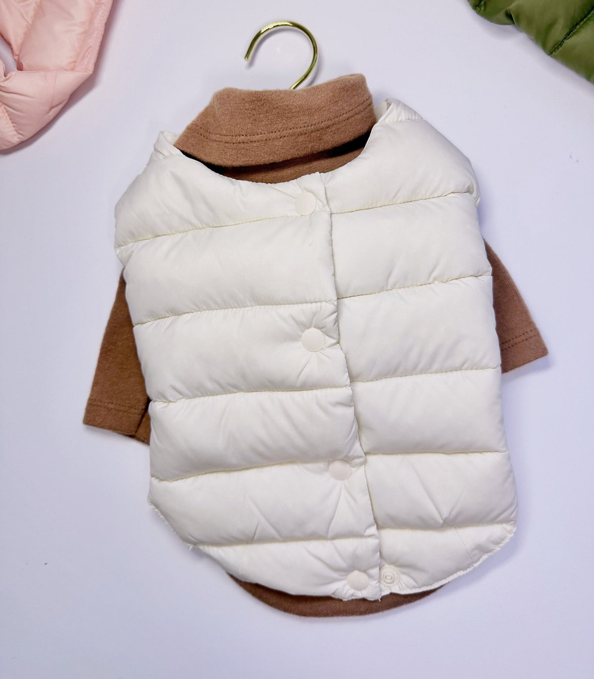 NKpup white duck down dog vest layered over a brown dog sweater