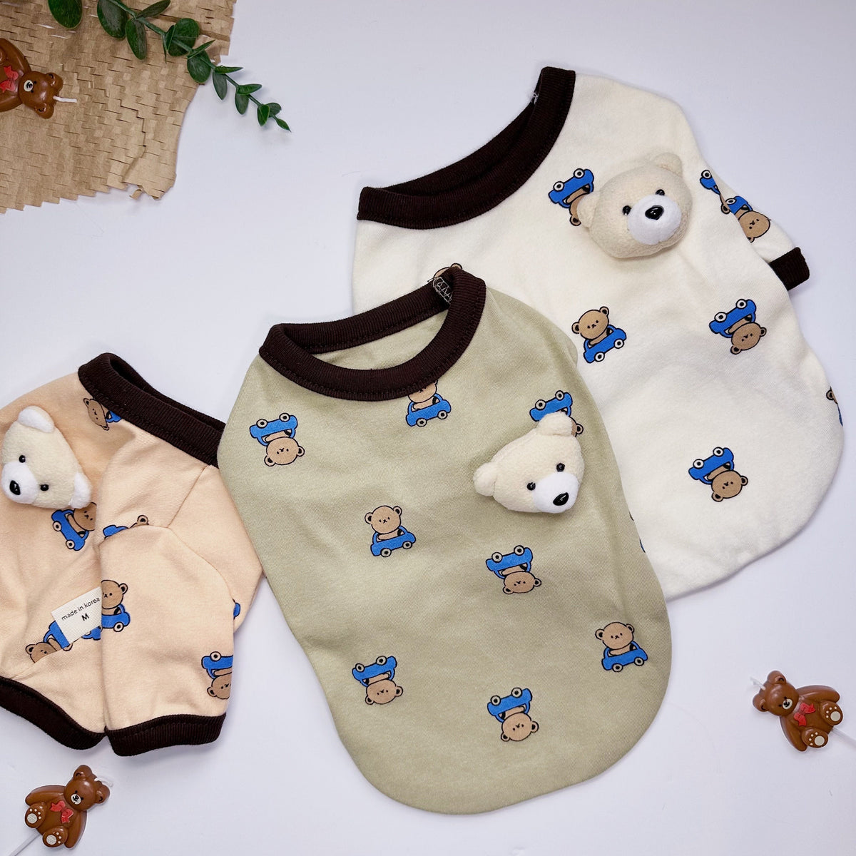 NKpup Teddy Bear Brooch T-shirts for dogs in cream, sage green, and peach colors.