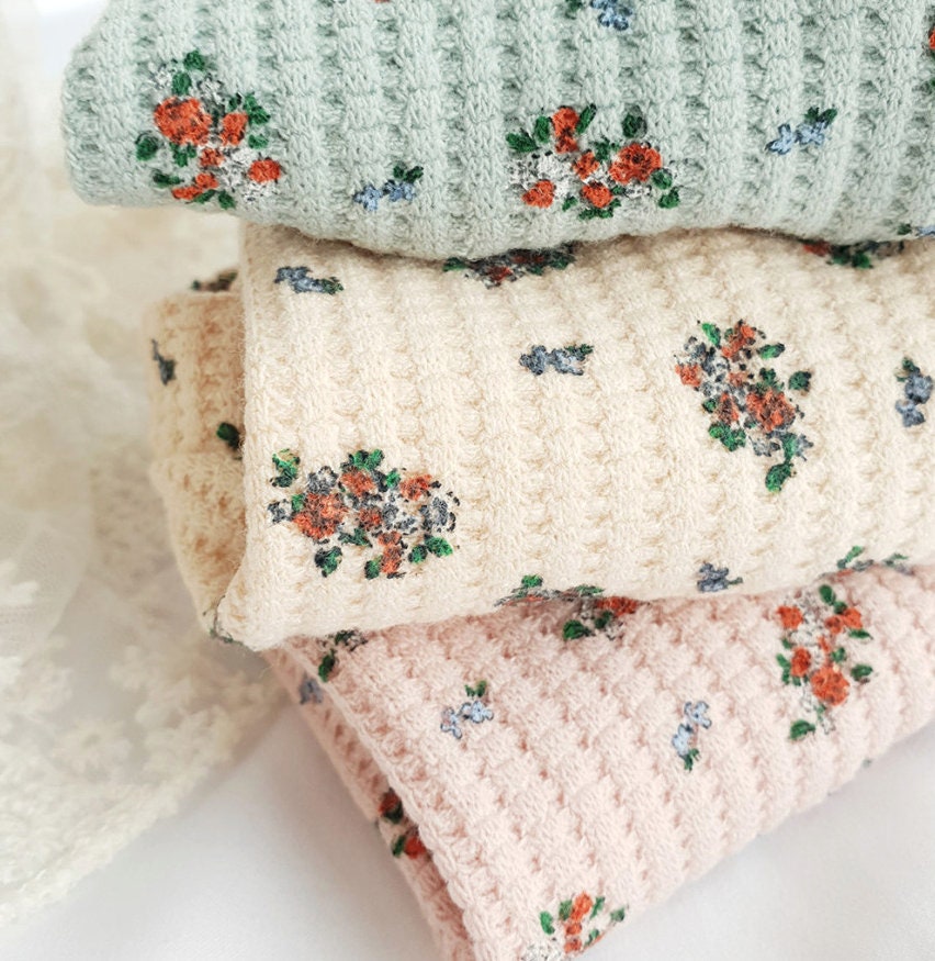 Floral pattern dog cardigan in sage green, cream, and soft pink waffle knit fabric.