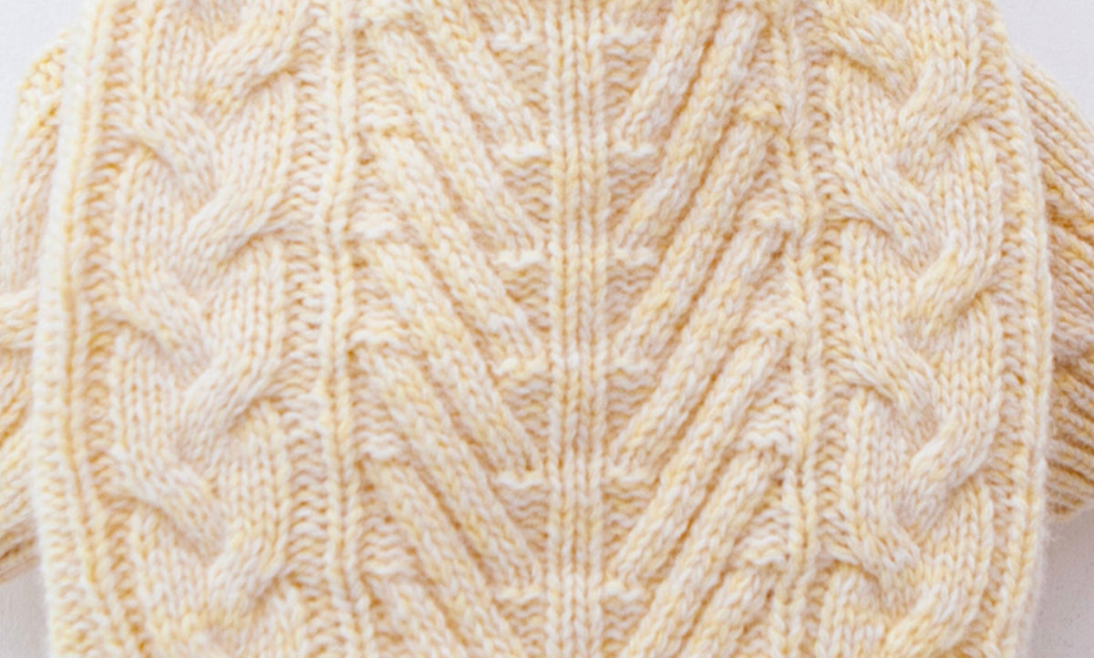 Cream yellow Toto cable knit dog sweater with textured patterns.
