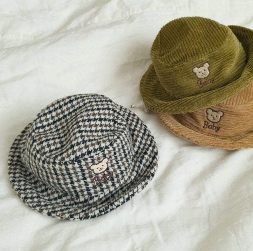 Three vintage bear-embroidered dog bucket hats in houndstooth, olive green, and tan corduroy.