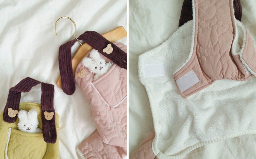 Pink and yellow padded dog overalls with plush bunny toy in pockets