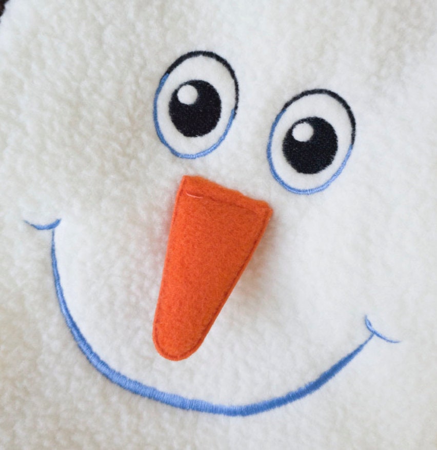 Close-up of the snowman face design on a white NKpup Christmas dog sweatshirt.