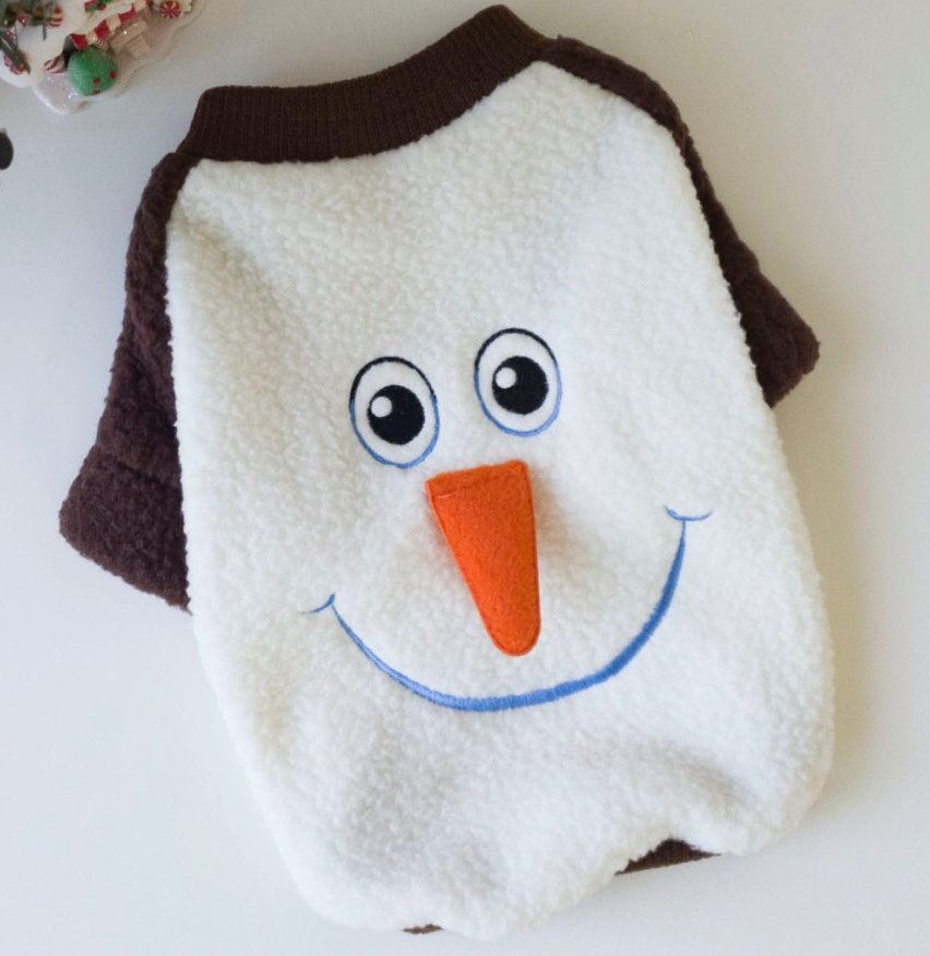 NKpup Christmas snowman dog sweatshirt with white fleece, orange carrot nose, and a smiling face.