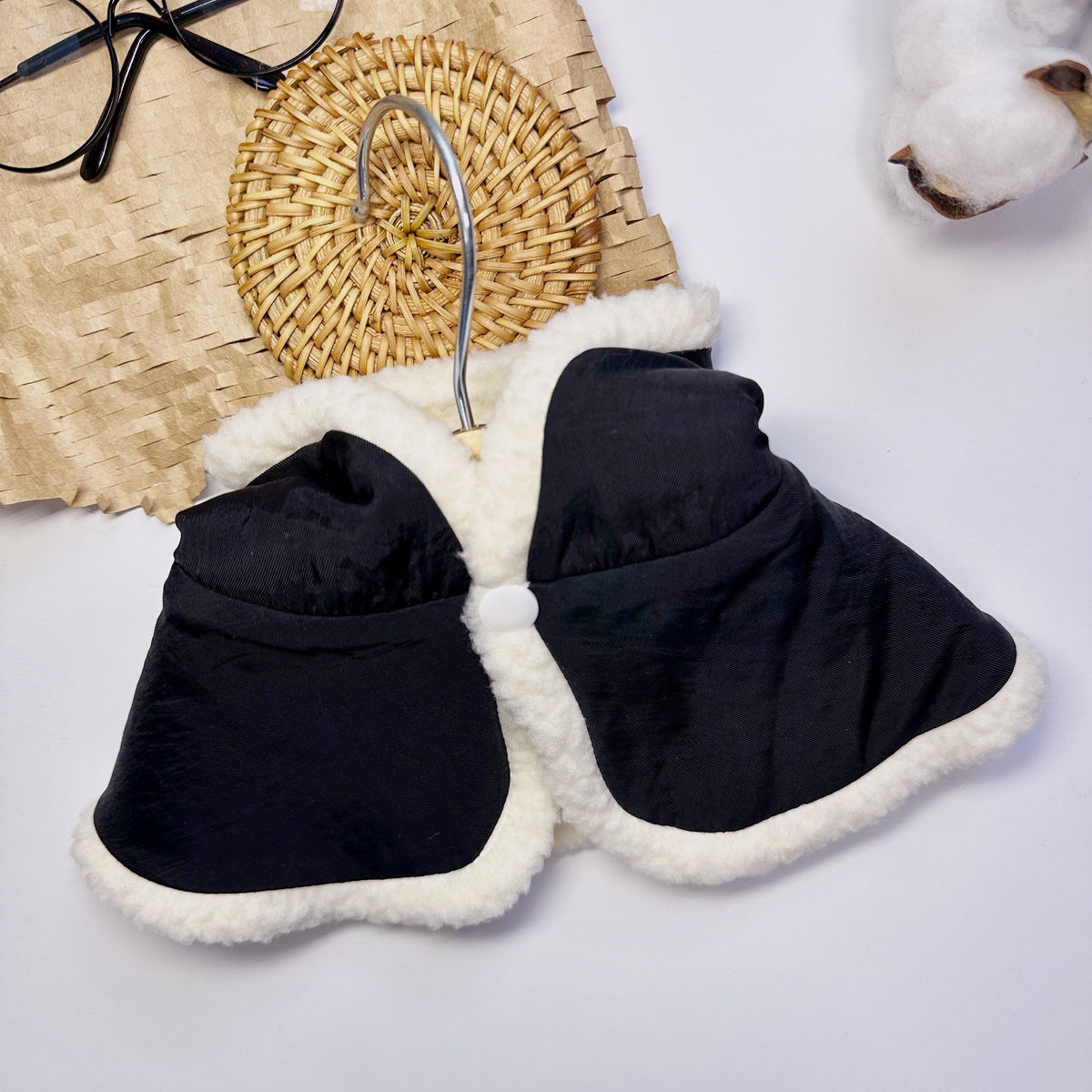 Black reversible dog hoodie cape with white faux fur trim.