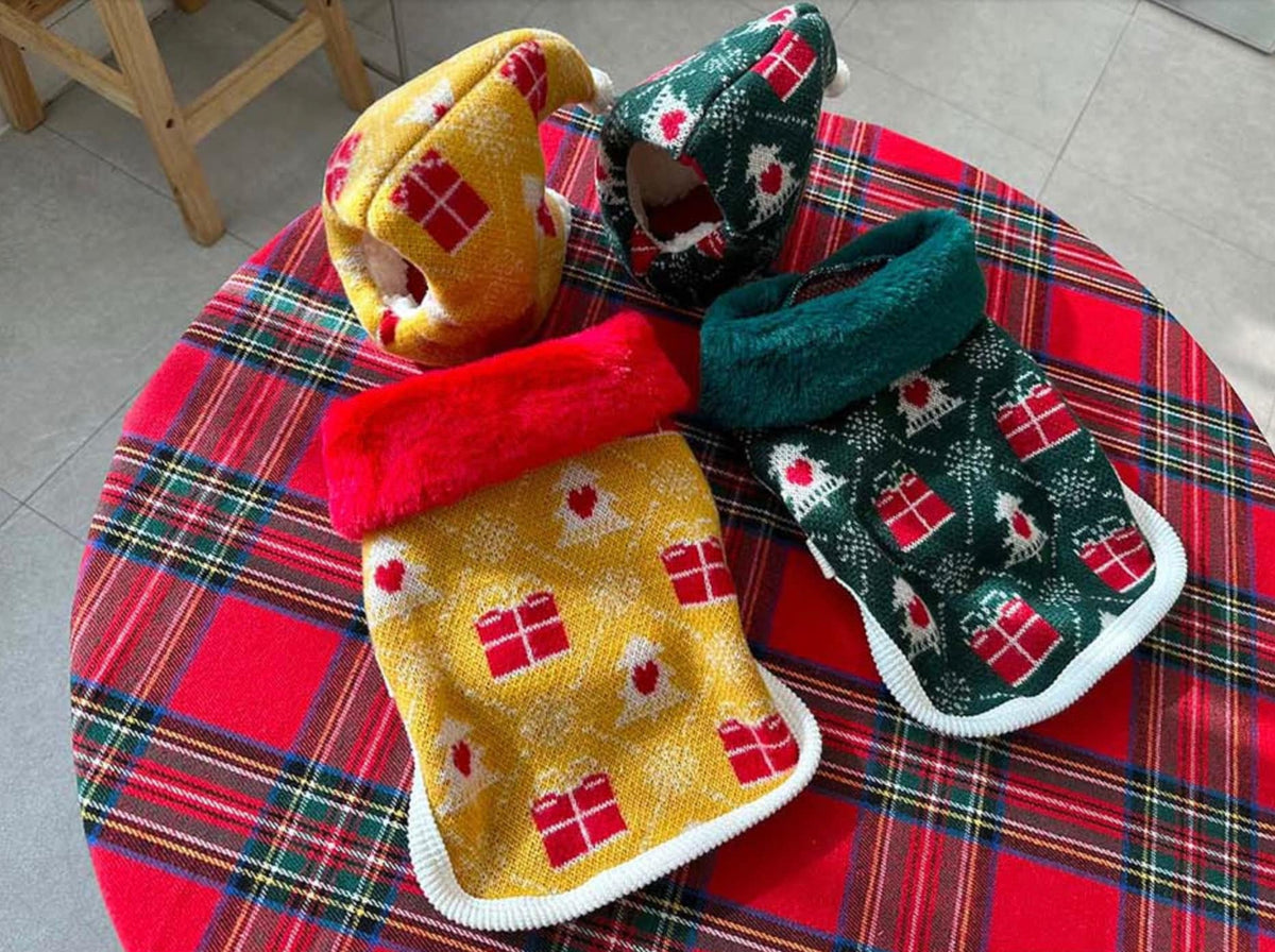 Set of four Christmas themed pet booties in yellow and green with red gift and tree patterns.