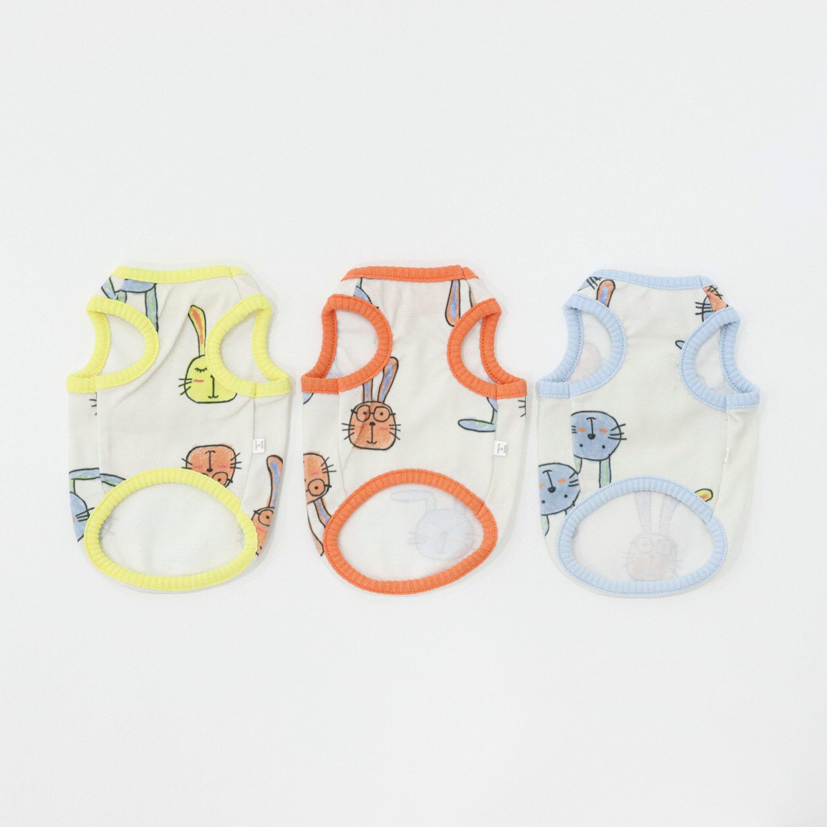 NKpup Rabbit Sleeveless Top dog shirts in white, orange, and blue with rabbit patterns