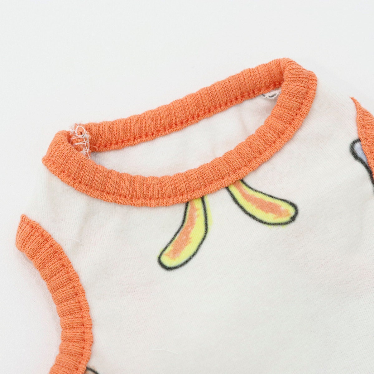 White Rabbit Sleeveless Top dog shirt with orange trim and green rabbit pattern