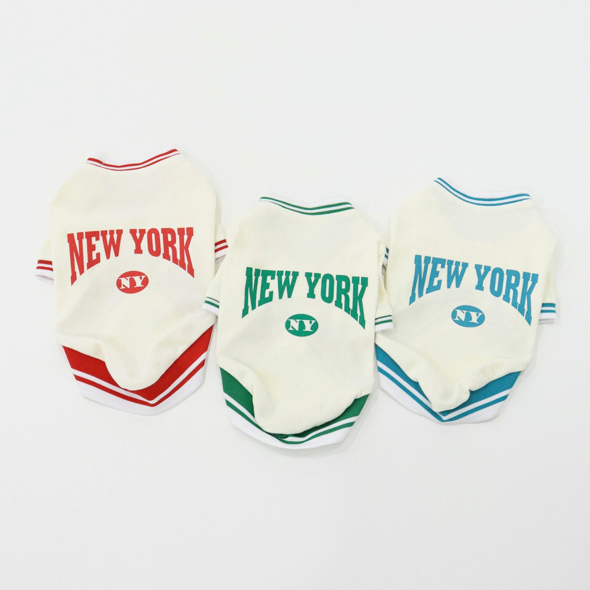 Three NKpup New York Jersey Tops for dogs in red, green, and blue colorways