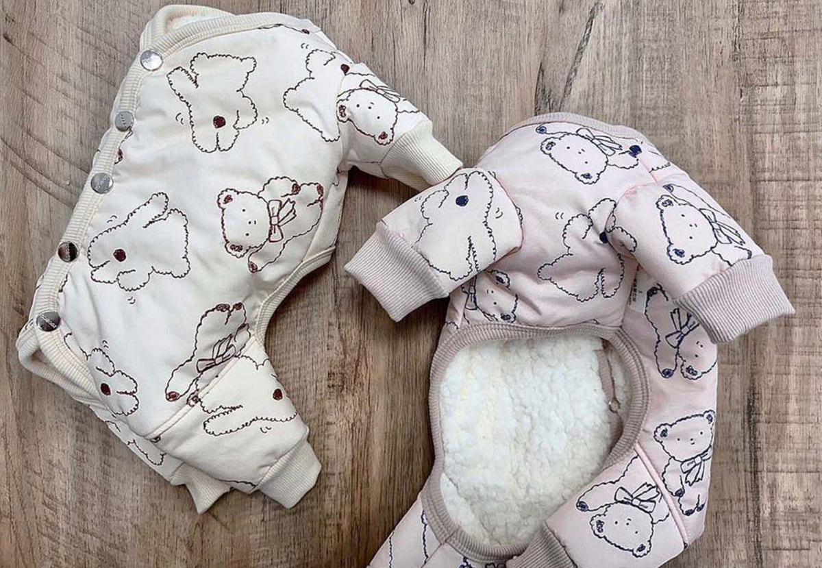 Two NKpup Ribbon Bear Padded Dog Overalls in cream and light pink with bear patterns.