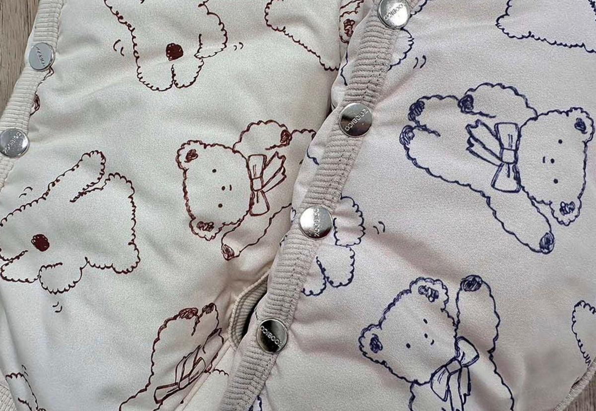 Ribbon Bear pattern padded dog overall in cream with silver snaps