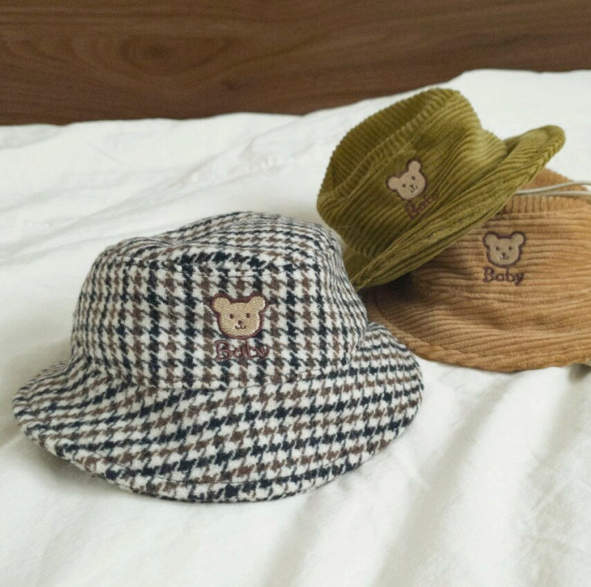 Three vintage bear dog bucket hats in houndstooth, olive green, and tan corduroy.