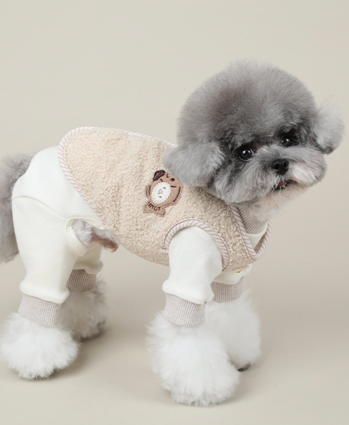 NKpup Daisy Fleece Dog Vest in cream with a teddy bear patch and ribbed cuffs