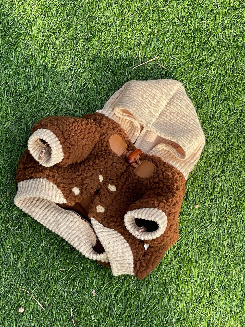Brown and cream NKpup duffle fleece dog jacket with a hood and wooden button details.