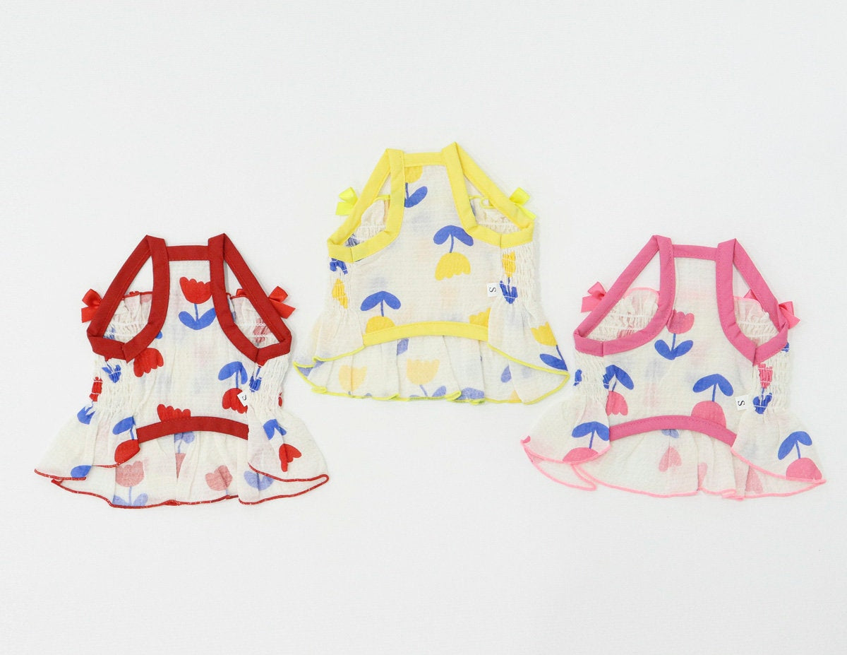NKpup Tulip Smocked Dog Dress in red, yellow, and pink floral patterns