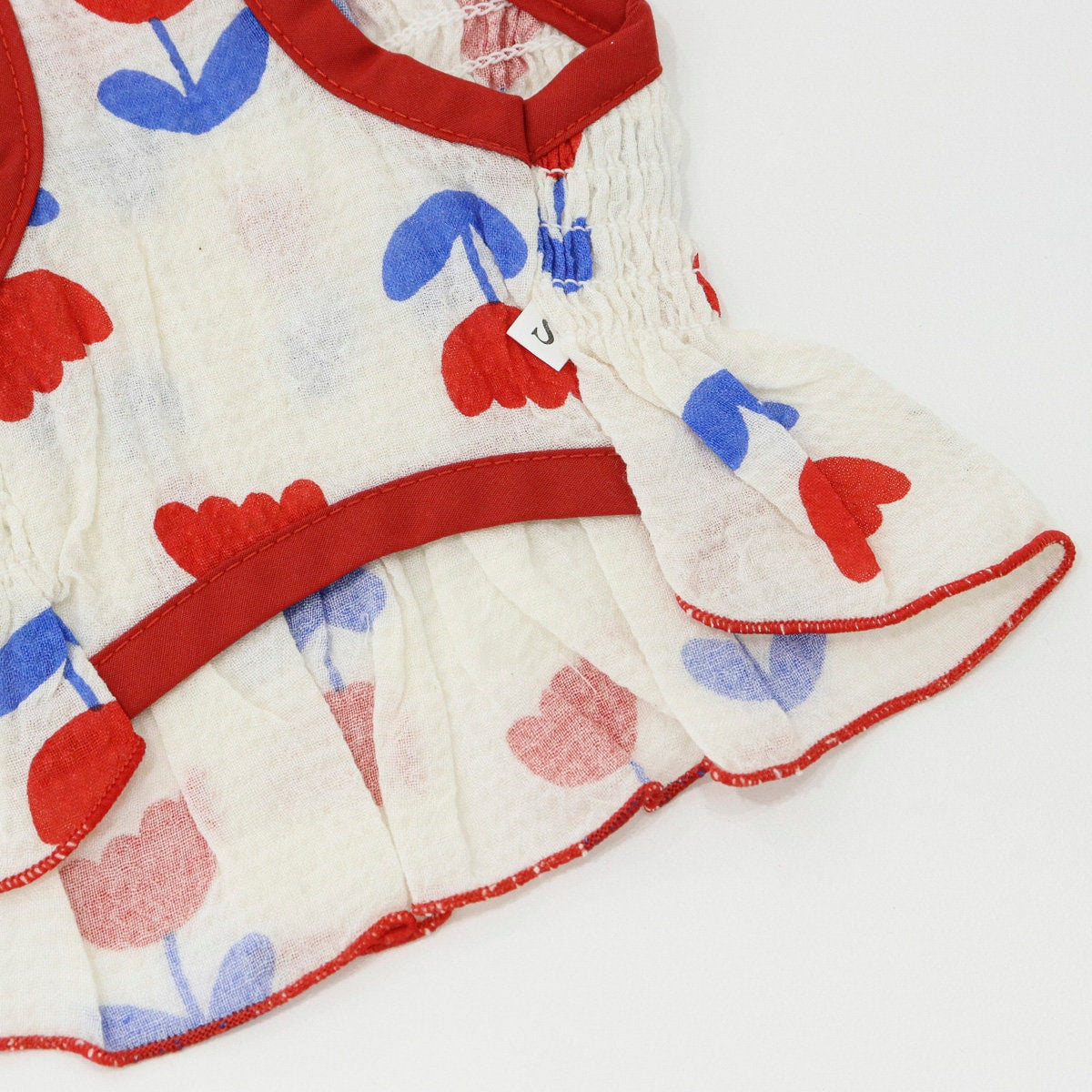 Tulip Smocked Dog Dress with red floral pattern and red trim