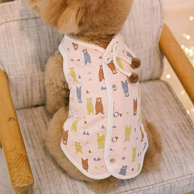 Pink quilted bear pattern dog vest with button closures and decorative tassels.