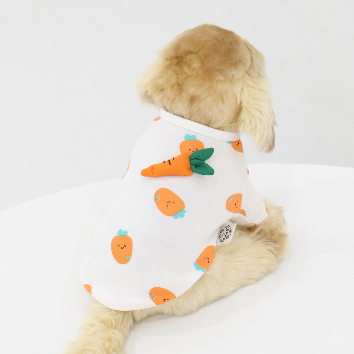White NKpup carrot dog shirt with orange carrot patterns and a 3D carrot applique